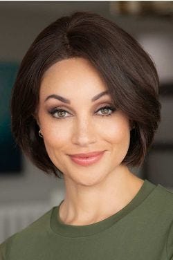 Woman in a chin length medium blonde curled-under straight bob wig