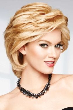 Raquel Welch in a light auburn heavily layered cropped bob wig with choppy bangs