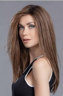 Woman in an extra long layered medium brown human hair/synthetic wig with long layers