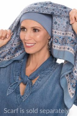 Woman placing a scarf over a denim padded bamboo headband