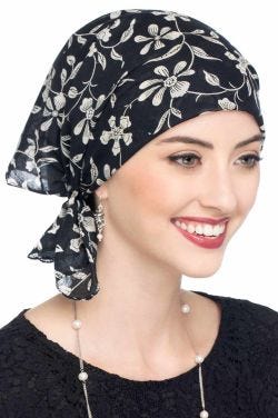 Woman in black large handmade oversized cotton bandana worn on the head
