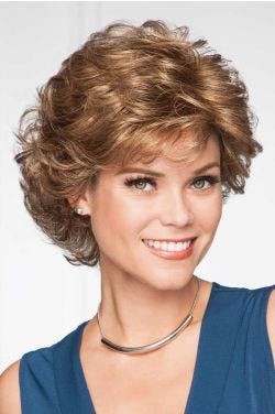 Woman in a voluminous, dark blonde, layered, long pixie wig with light fringe bangs