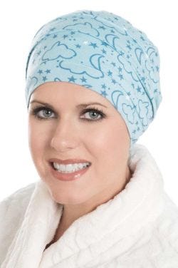 Woman in blue moon and stars print bamboo sleeping cap for women with cancer