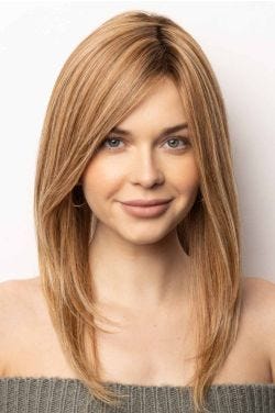 Woman in an extra long light auburn human hair wig with long layers