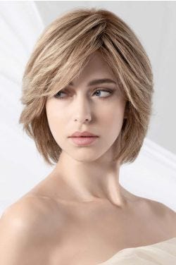 Woman in a long blonde chin length bob wig with long bangs and layers