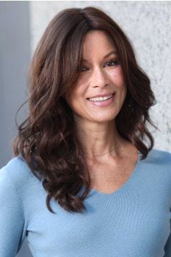 Woman in an extra long wavy dark brown lace front wig