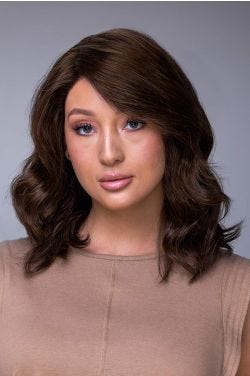 Woman in a petite shoulder length dark brown curly human hair wig
