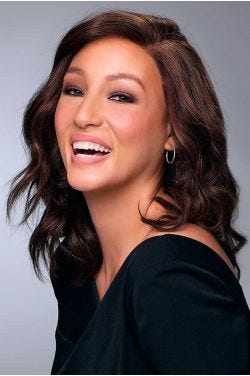 Woman in a shoulder length dark auburn curly human hair wig