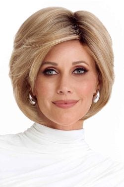 Woman in a long layered light brown pixie wig with side bangs