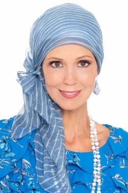 Woman in blue stripe chiffon head scarf worn as a head covering for women