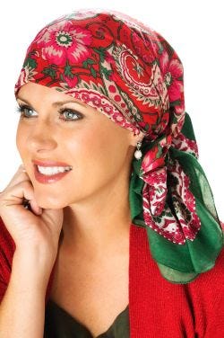 Woman in red hand stamped pre tied head scarf for cancer patients