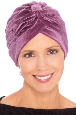 Woman in pink velour turban for women with cancer