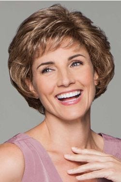 Happy woman in large light brown cropped and curly layered bob wig with textured short bangs