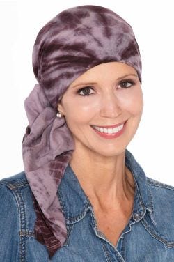 Women in brown tie dye square head scarf for women tied into bow