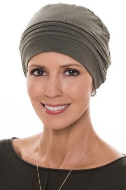 Woman in olive chemo cap with pleating at crown for cancer patients