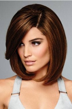 Raquel Welch in a shoulder length reddish blonde bob wig with long side bangs