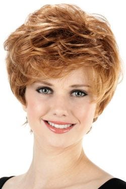 Woman in a long light auburn messy pixie wig