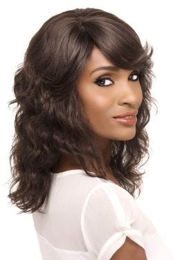 Black woman in a past the shoulders curly dark brown human hair wig with side bangs