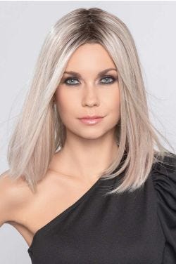 Woman in a past the shoulders platinum blonde straight blunt lace front wig