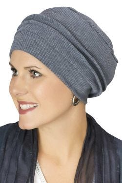 Woman in blue cancer turban with multiple pleats