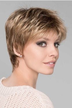 Woman in a classic light brown pixie wig with textured bangs