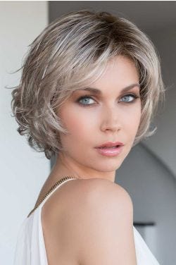 Woman in a chin length ash blonde bob wig with side bangs