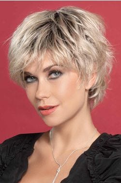 Woman in a long messy light blonde pixie wig with textured layers