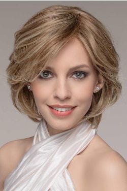 Woman in a long blonde chin length bob wig with long bangs and layers