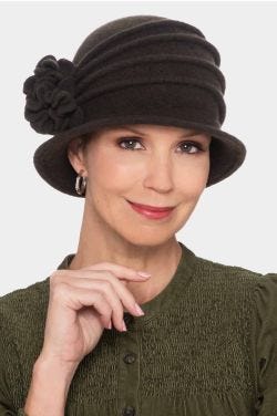 Woman in wool felt cloche winter hat with brim, pleating and flower on the side