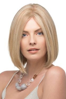 Woman in a shoulder length curled under dark blonde blunt human hair bob wig