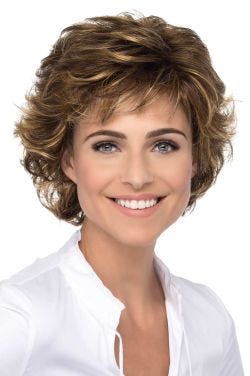 Woman in a chin length short medium brown wig with wispy bangs