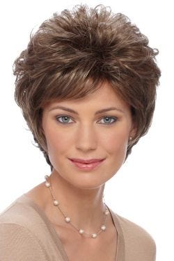 Woman in a short curly warm brown wig with side bangs