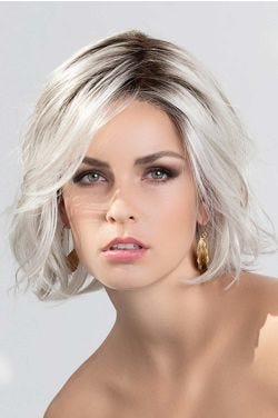 Woman in a past the chin curly white lace front wig