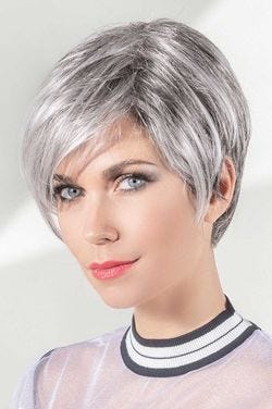 Woman in an asymmetrical short light grey pixie wig with longer layers in front and side bangs