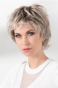 Woman in a long tousled light blonde lace front pixie wig