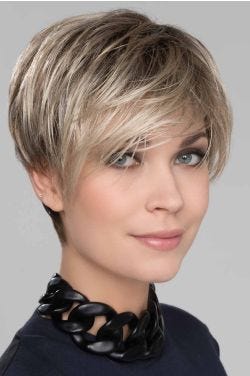 Woman in a medium blonde pixie wig with longer edgy layers on top