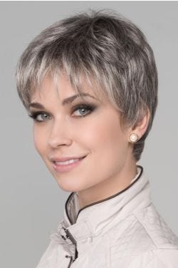 Woman in a large cropped salt and pepper lace front pixie wig with wispy bangs