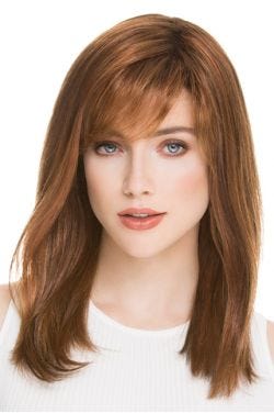 Woman in a past the shoulders medium auburn blunt cut wig with side bangs