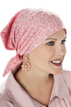 Woman in pink lace pre tied head scarf for cancer patients