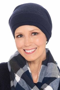 Woman in cute blue winter beanie hat with shimmery accents