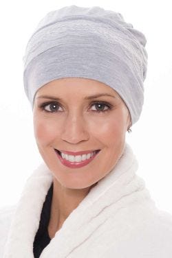 Woman in grey heather bamboo sleep cap with lace accents for chemo or women with hair loss