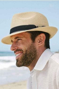 Cool guy on beach in brimmed straw men's fedora hat