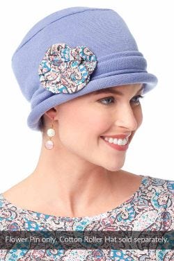 Woman in a denim Cotton Roller Hat with a multi-paisley bamboo flower pin attached