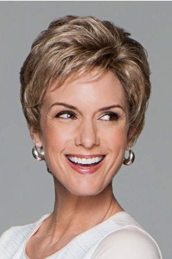 Woman in a curly dark blonde pixie wig with longer layers on the top and back