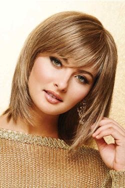Woman in a dark blonde shoulder length bob wig with razored ends and side swept bangs