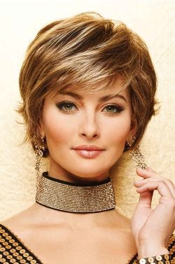 Woman in short, close cropped bob wig with medium brown hair, copper highlights, and side swept bangs