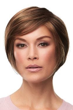 Woman in a layered chin length medium auburn rounded bob wig with bangs
