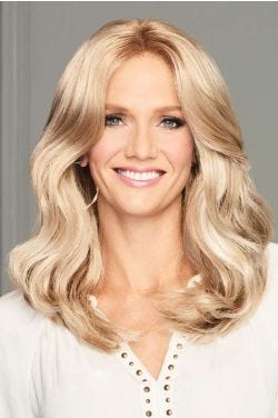 Woman in a past the shoulders light blonde wavy lace front wig