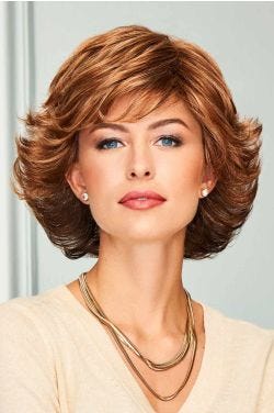Woman in a medium red bob wig with ample volume and blown out, curled up ends