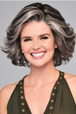 Woman in a blown out past the chin grey and black curly wig